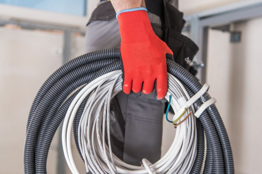 Closeup of an electricians hand holding cables